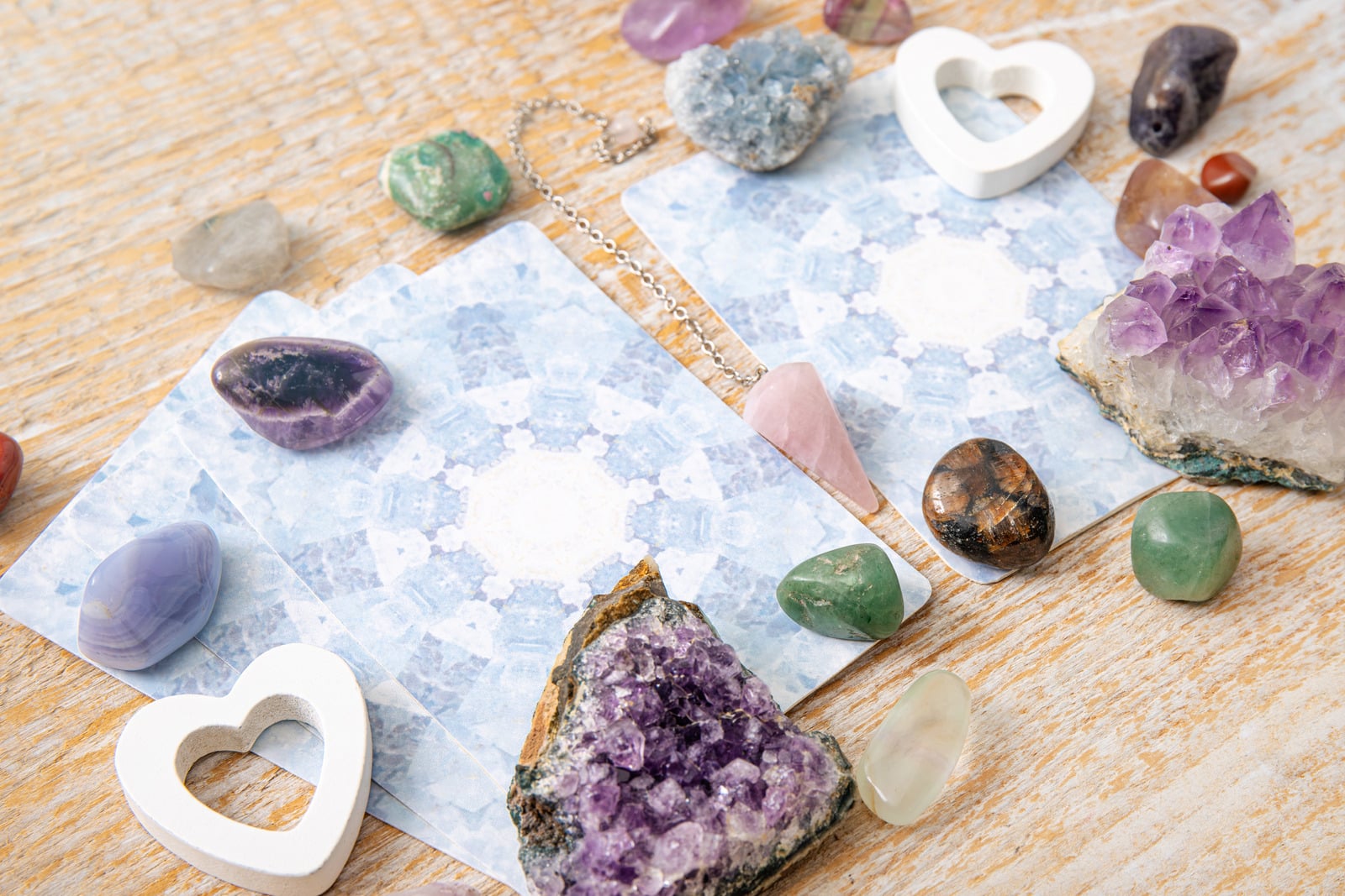 Healing crystals arranged on natural wood, reflecting Jordan's intuitive approach to astrology