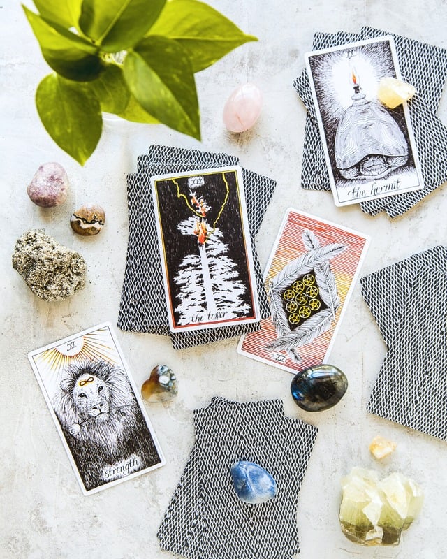 Oracle and tarot cards with crystals laid out for an intuitive oracle session