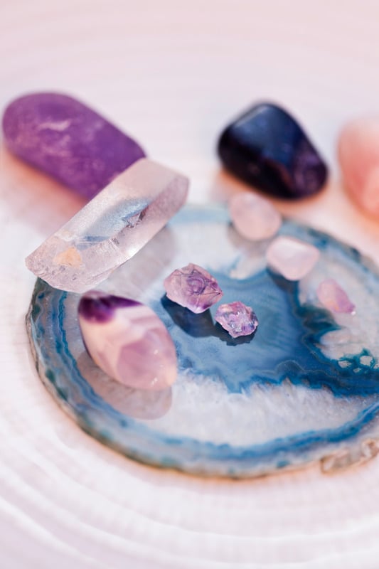 Crystals on a blue agate slice, for the ongoing astrology coaching program